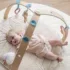 Offrez à bébé des moments d'éveil inoubliables avec le tapis d'éveil Nattou Mila, Lana et Zoé. Design en bois beige, arches ludiques et douceur extrême. Livraison rapide au Maroc !